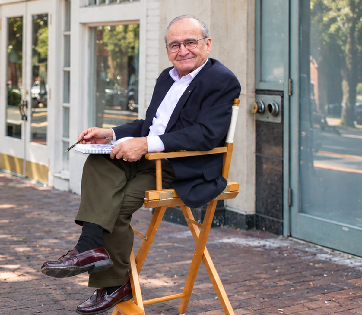 Charles Parrish seated outdoors with a notebook